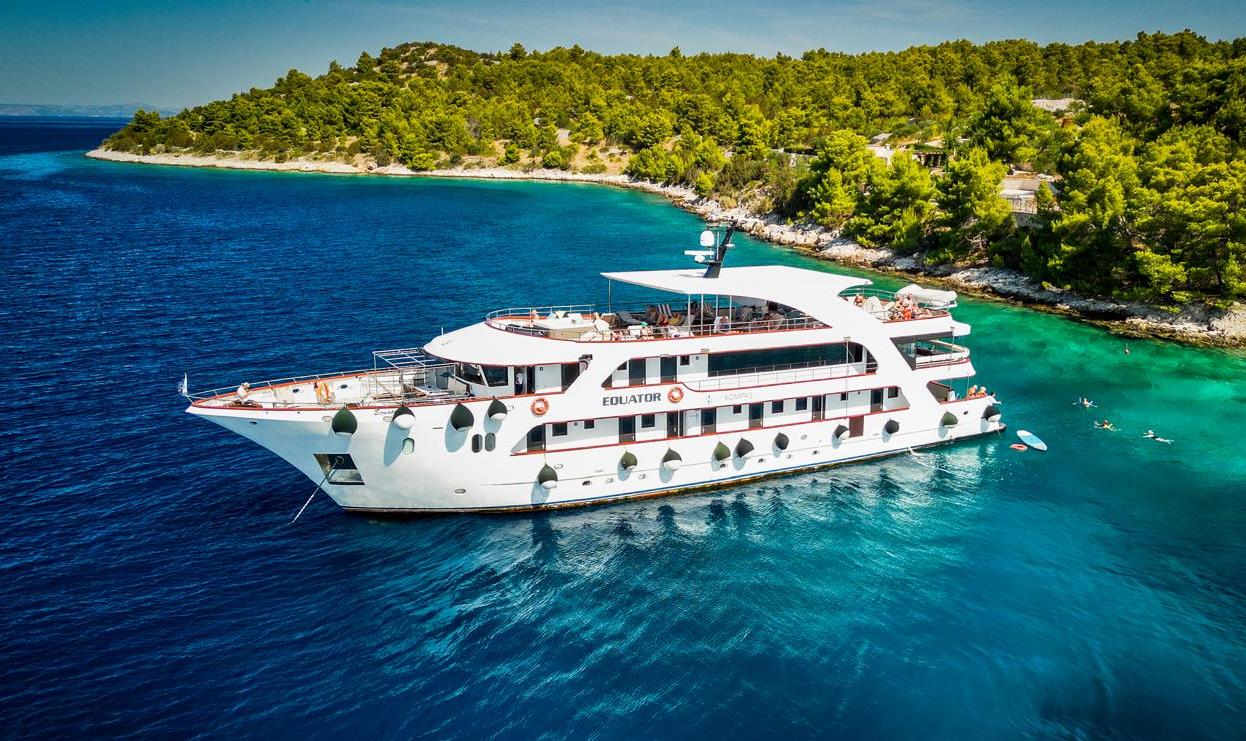 Aerial view of the Equator cruise ship in Croatia, with people paddleboarding nearby.