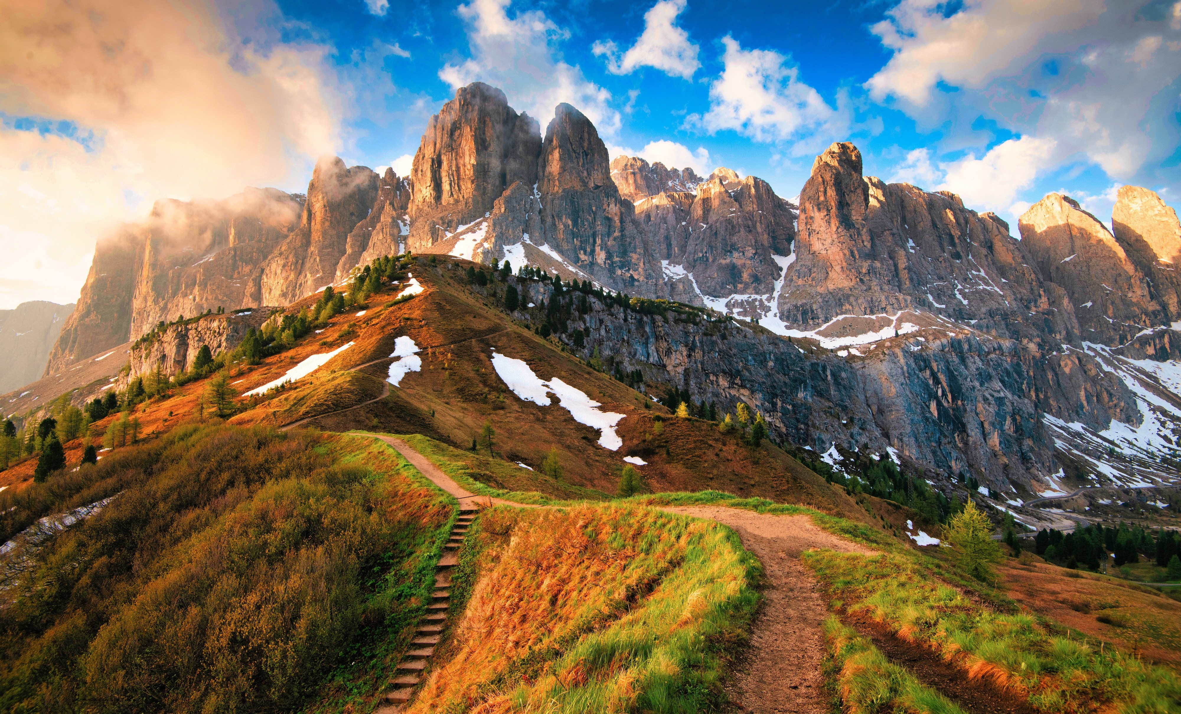 a path in the mountains with stairs leading up to the top