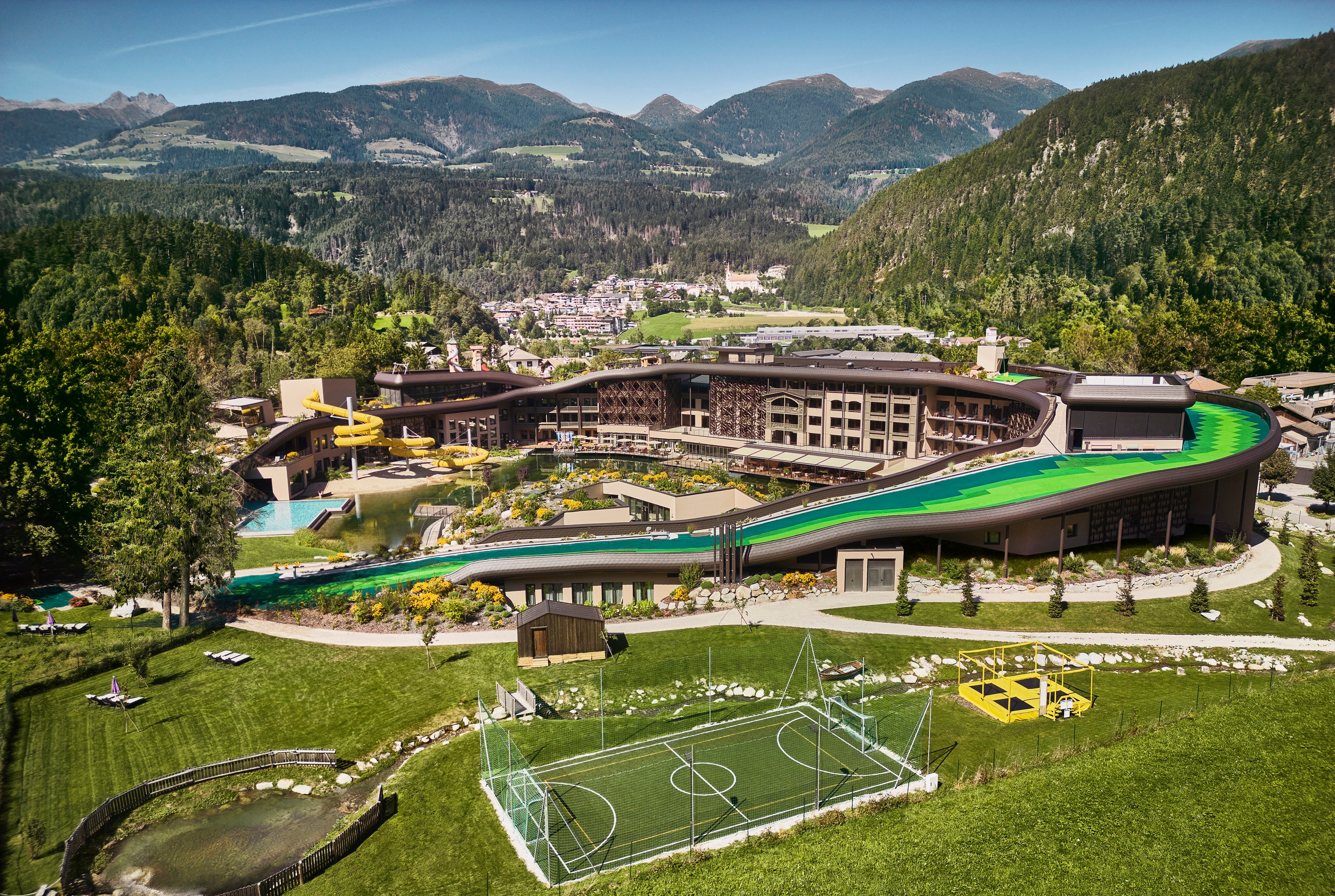 an aerial view of a resort with mountains in the background