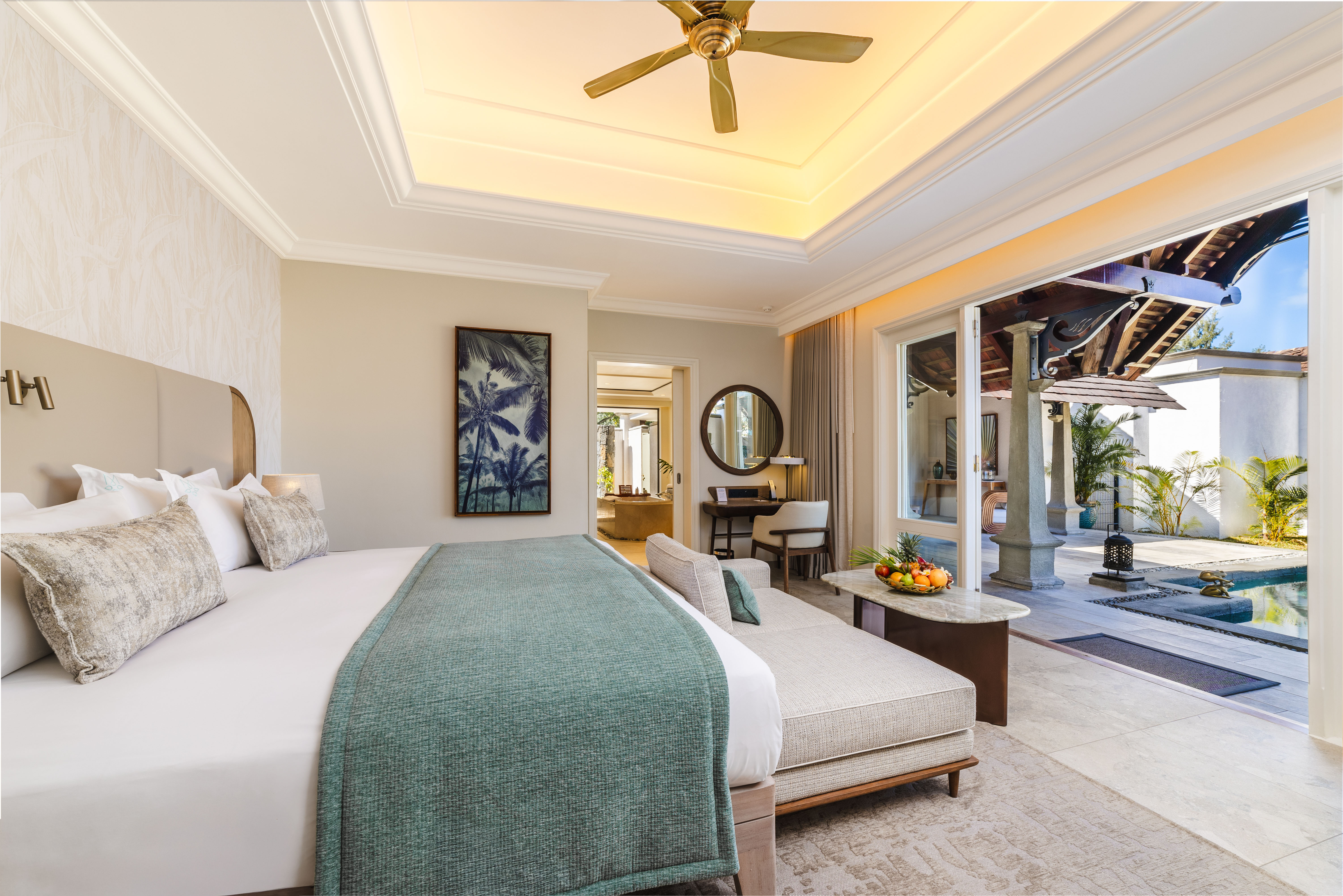 Bedroom with king-size bed, private patio, and pool view.