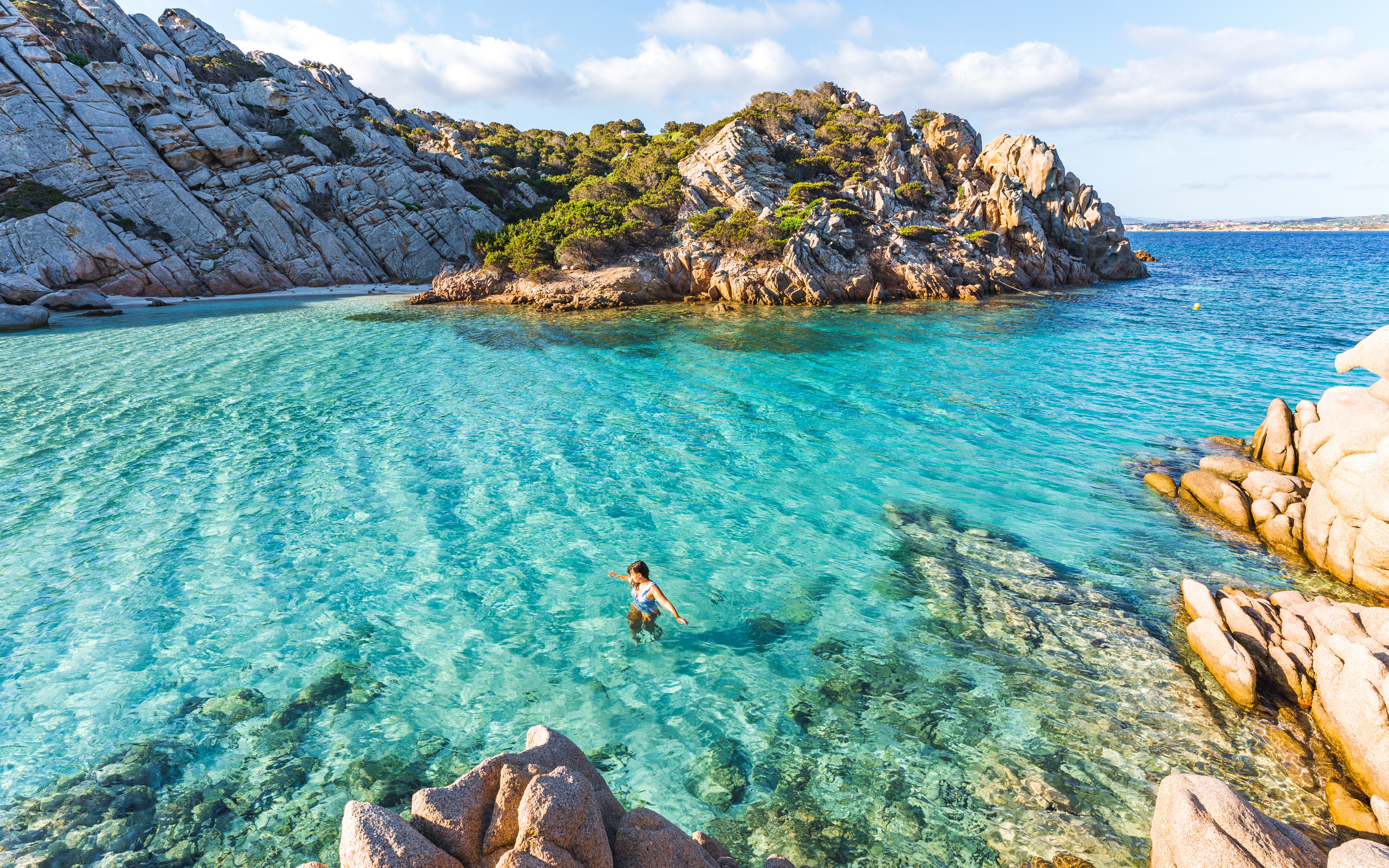 Woman swimming in Cala Napoletana, Sardinia.
