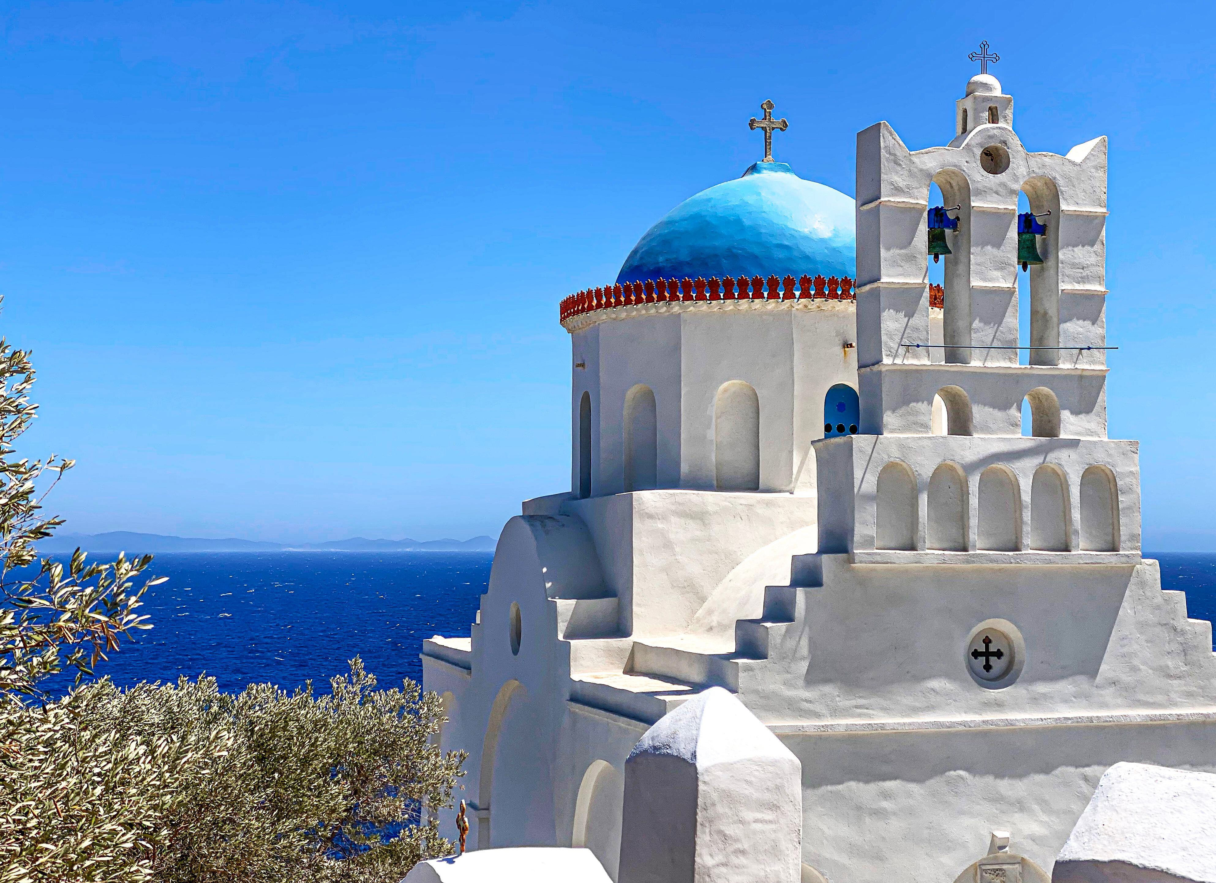A traditional blue-domed building in Sifnos, Greece, ideal for summer vacations.