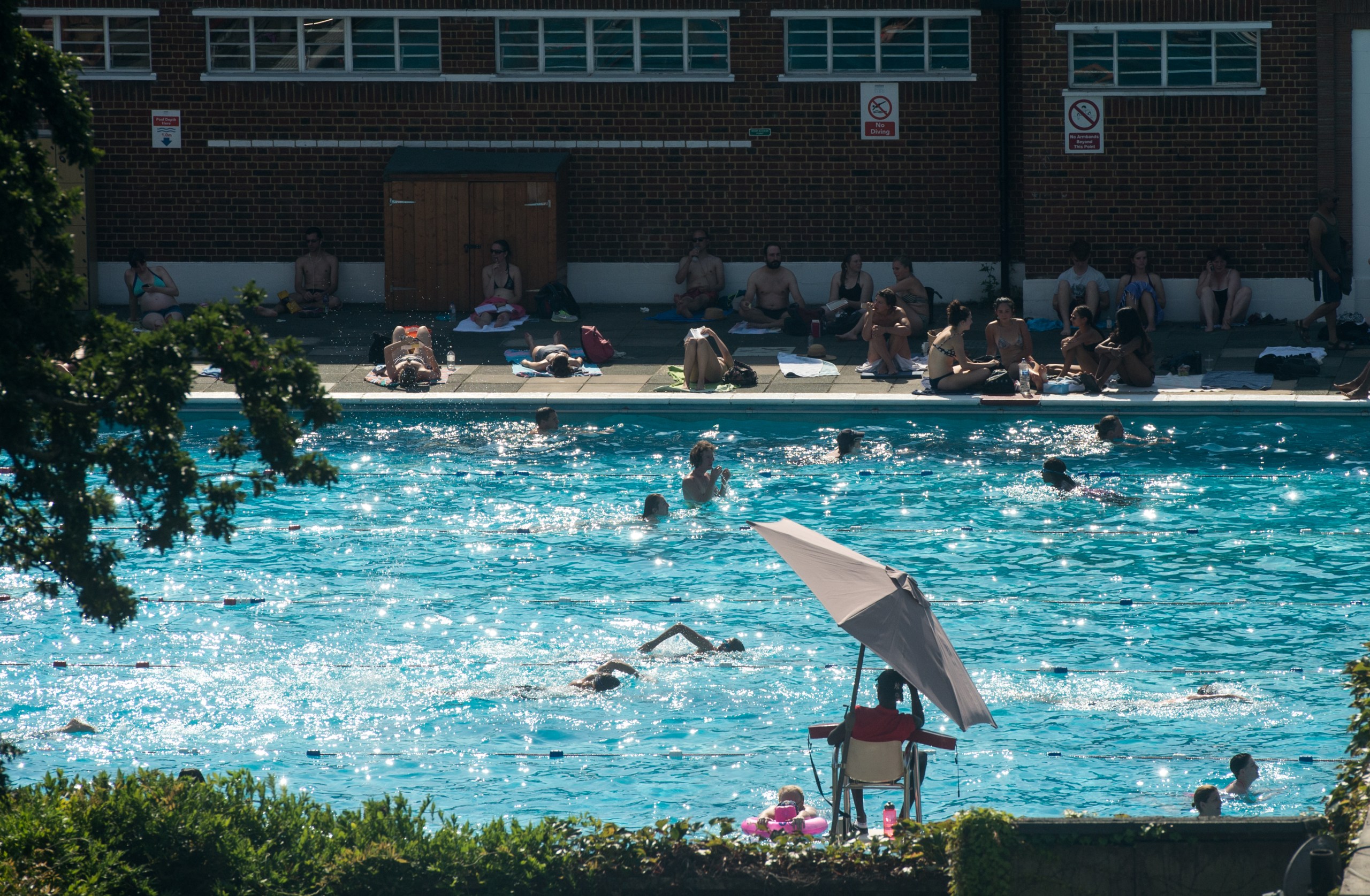 A lifeguard watches over swimmers at Brockwell Lido, one of the best places to keep cool in the London heatwave