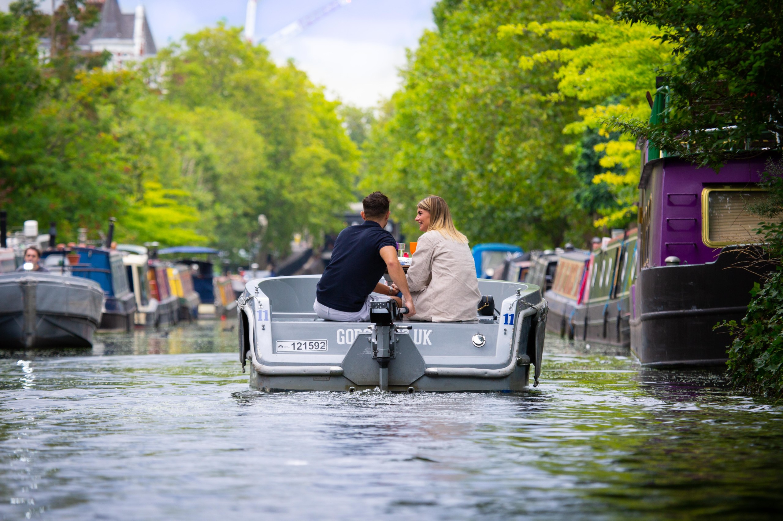 People in a GoBoat boat on Regent's Canal, London, one of the best places to keep cool in the London heatwave